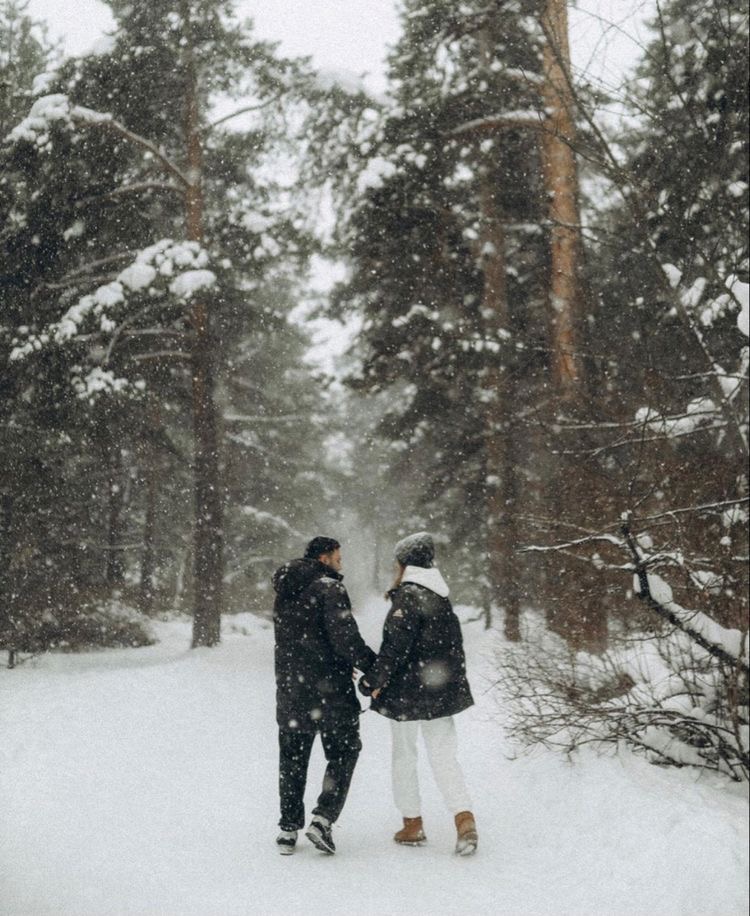 Couple walking in the winter forest